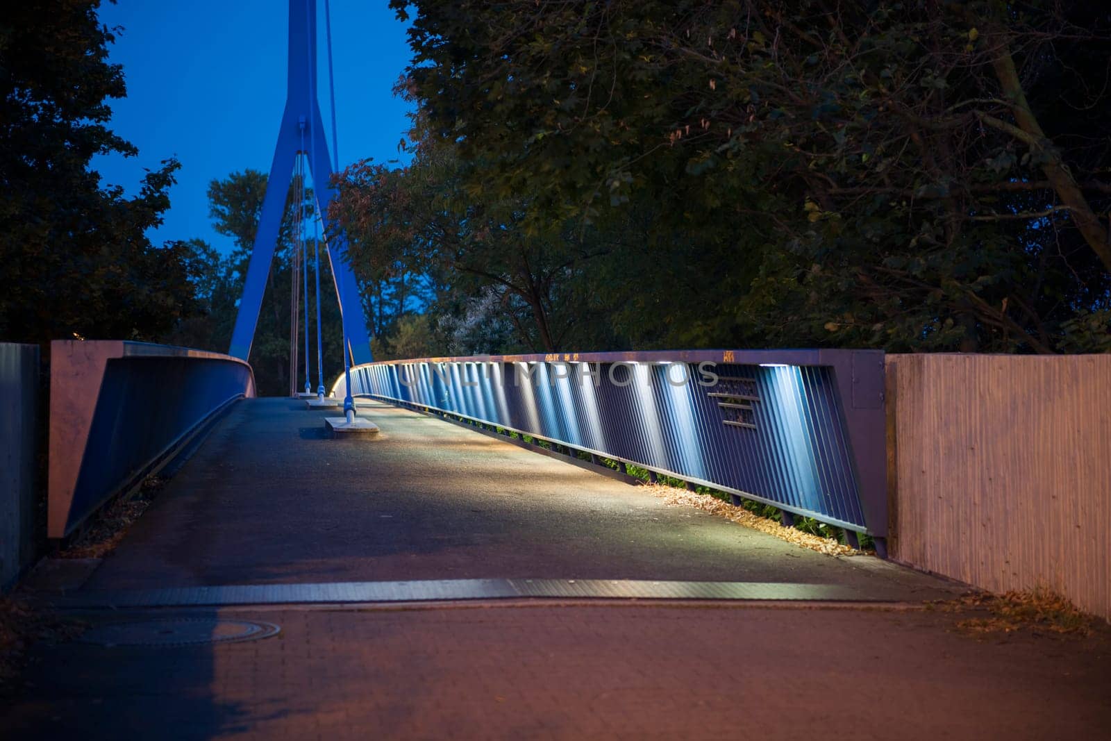 perspective view over pedestrian bridge Hoher Bogen over the Stadt-Autobahn in Berlin at night in the moonlight