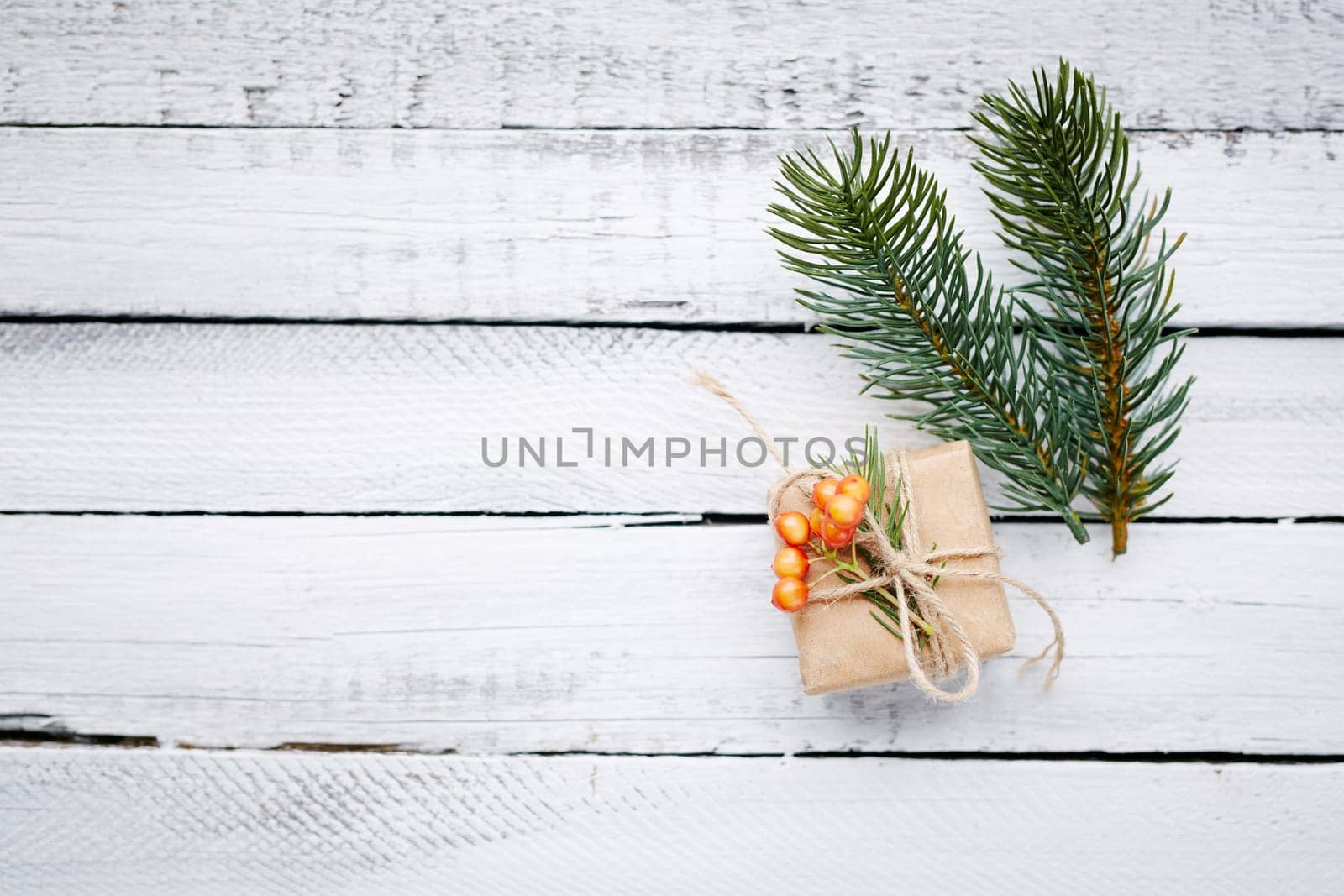 Small package and firtree conifer over wooden background
