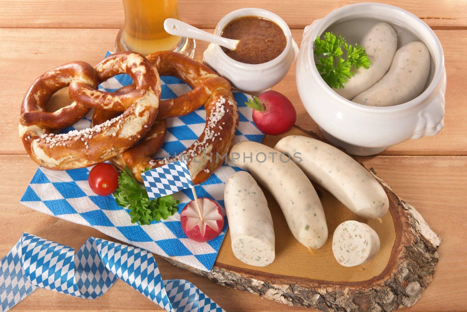 White sausage breakfast with sausages,pretzels,white beer and sweet mustard on wood substrate