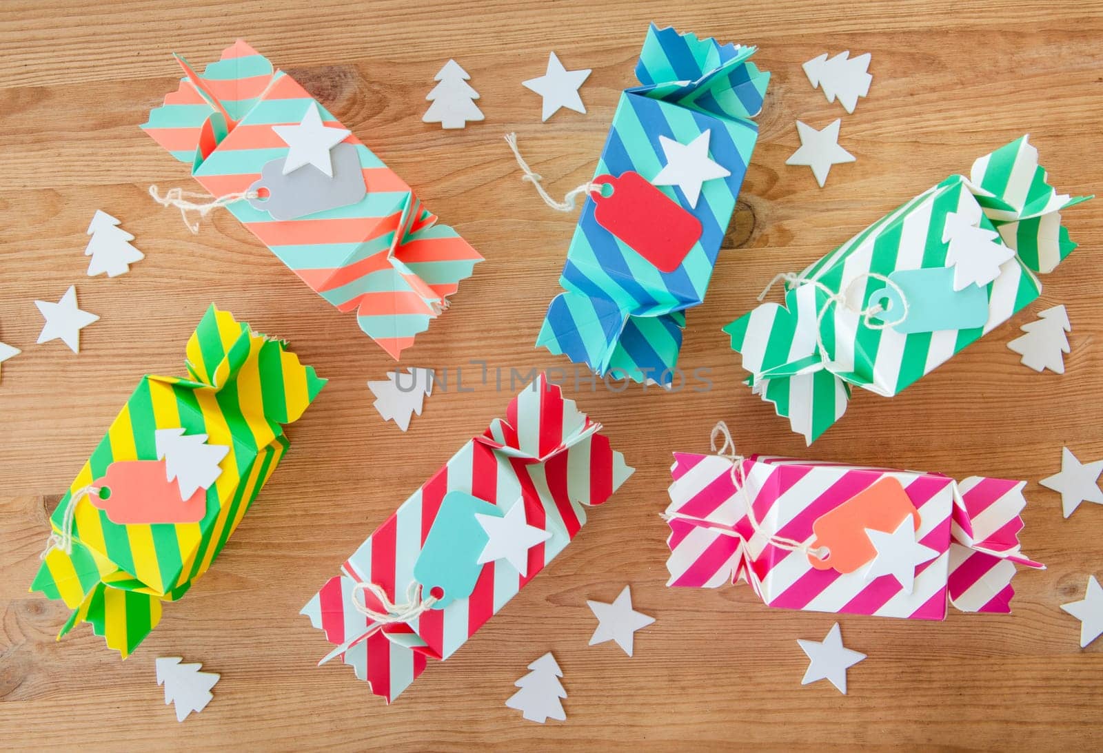 Small colorful gifts for Christmas on rustic background made of wood