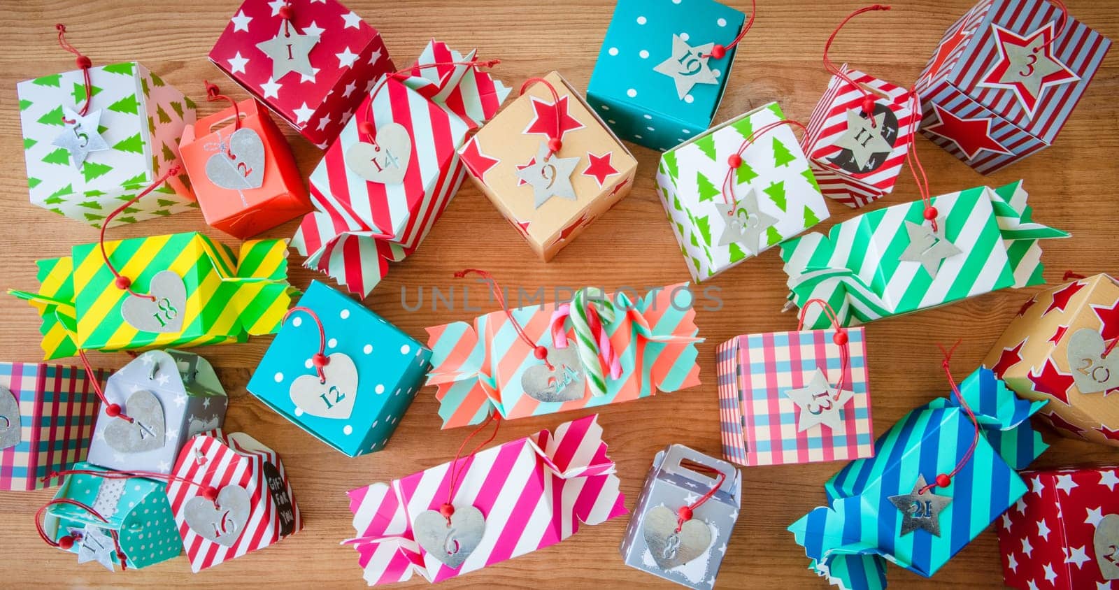 Small colorful gifts for Christmas on rustic background made of wood