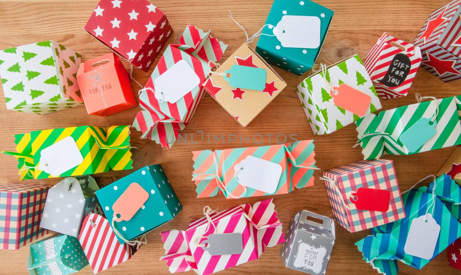 Small colorful gifts for Christmas on rustic background made of wood