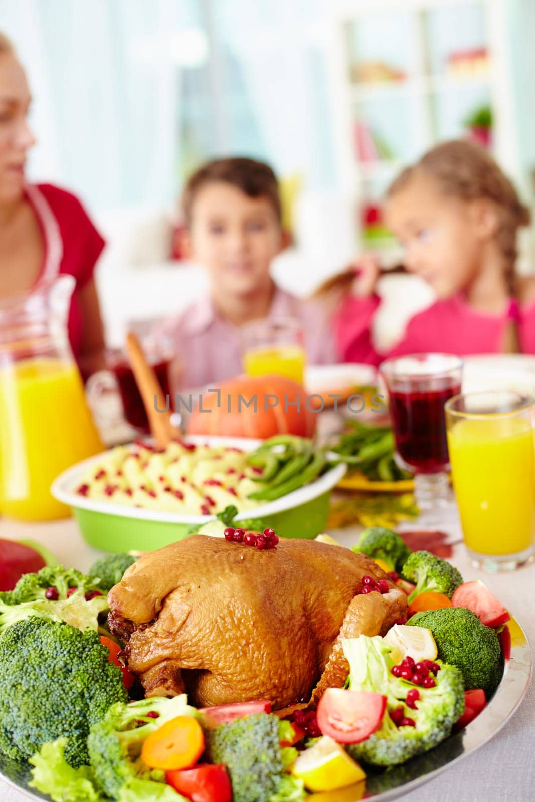 Homemade roasted turkey surrounded with vegetables on served table