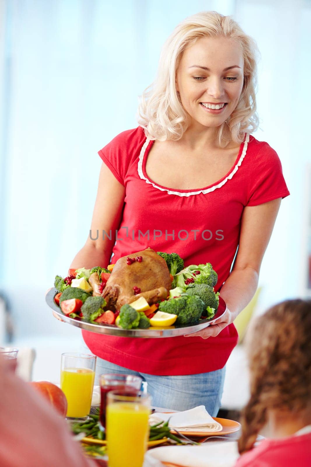 Happy young woman with roasted Thanksgiving turkey