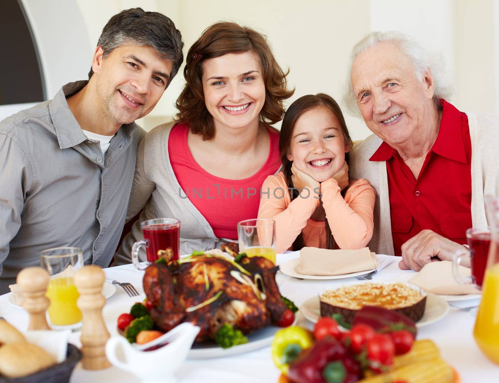 Happy family sitting at celebration table on Thanksgiving Day