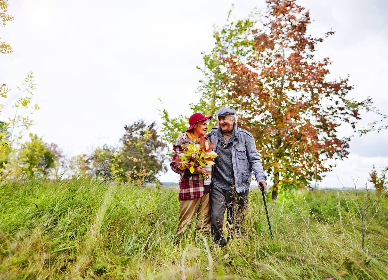 Happy senior couple walking in park on weekend