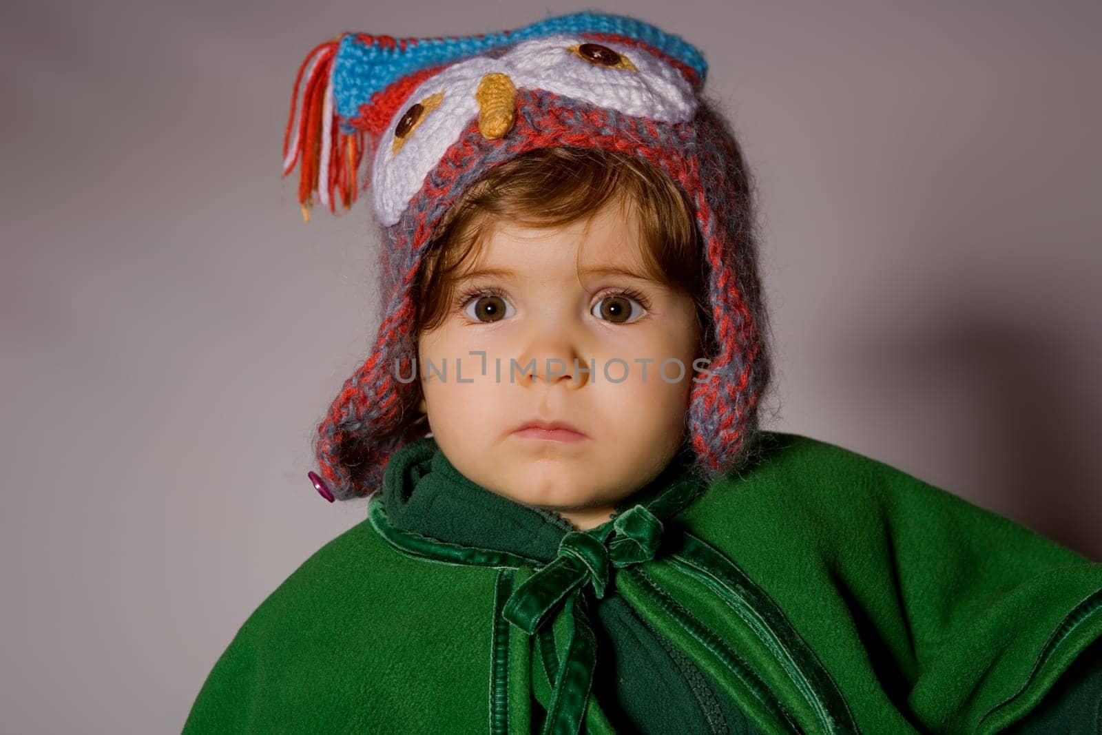 young baby portrait on a grey background