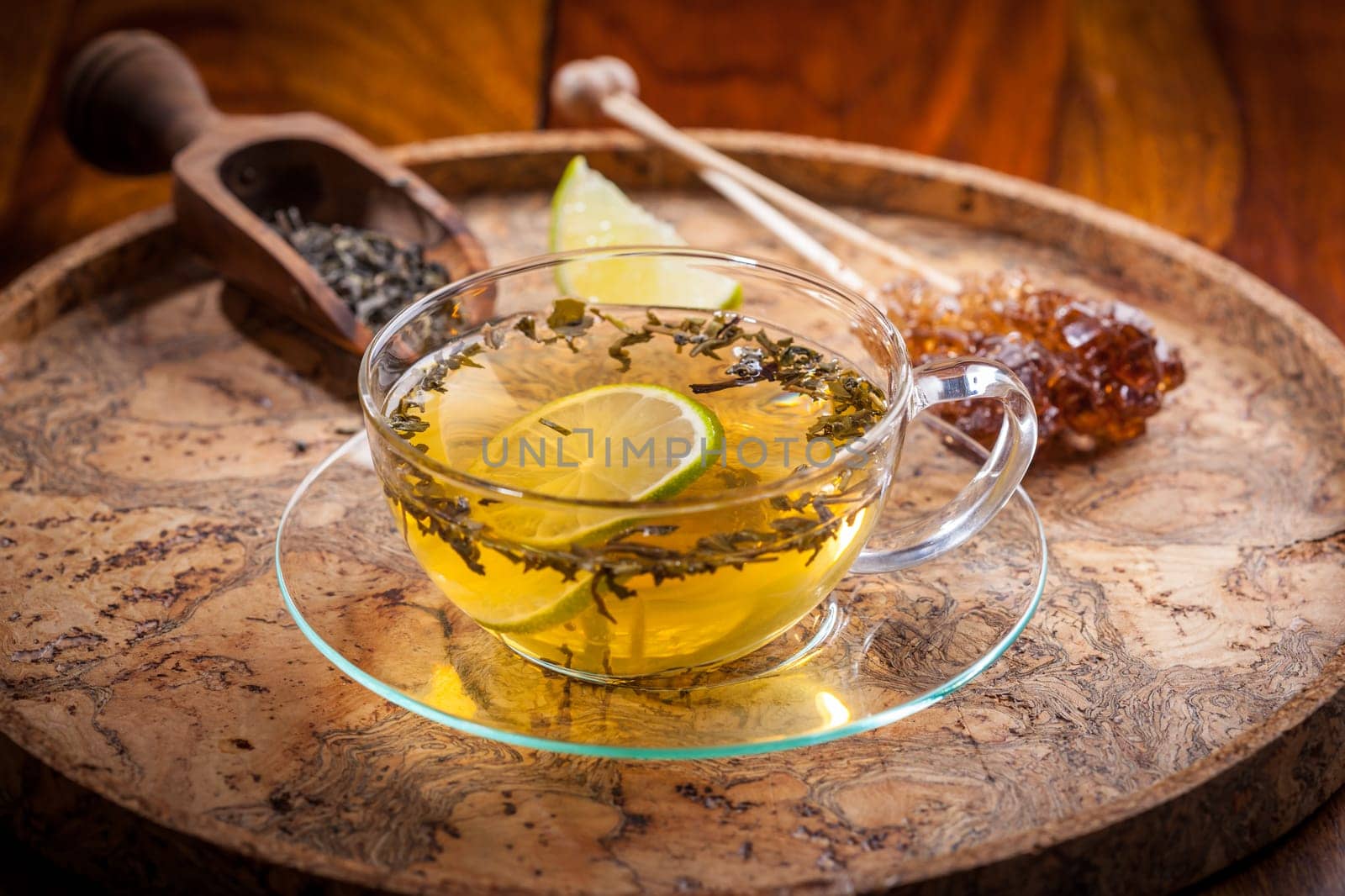 Cup of green tea with dried tea leaves