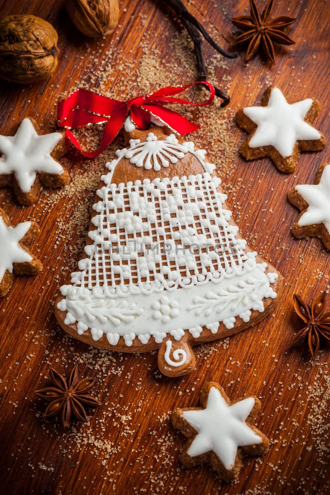 Homemade gingerbread bell for Christmas with baking ingredients