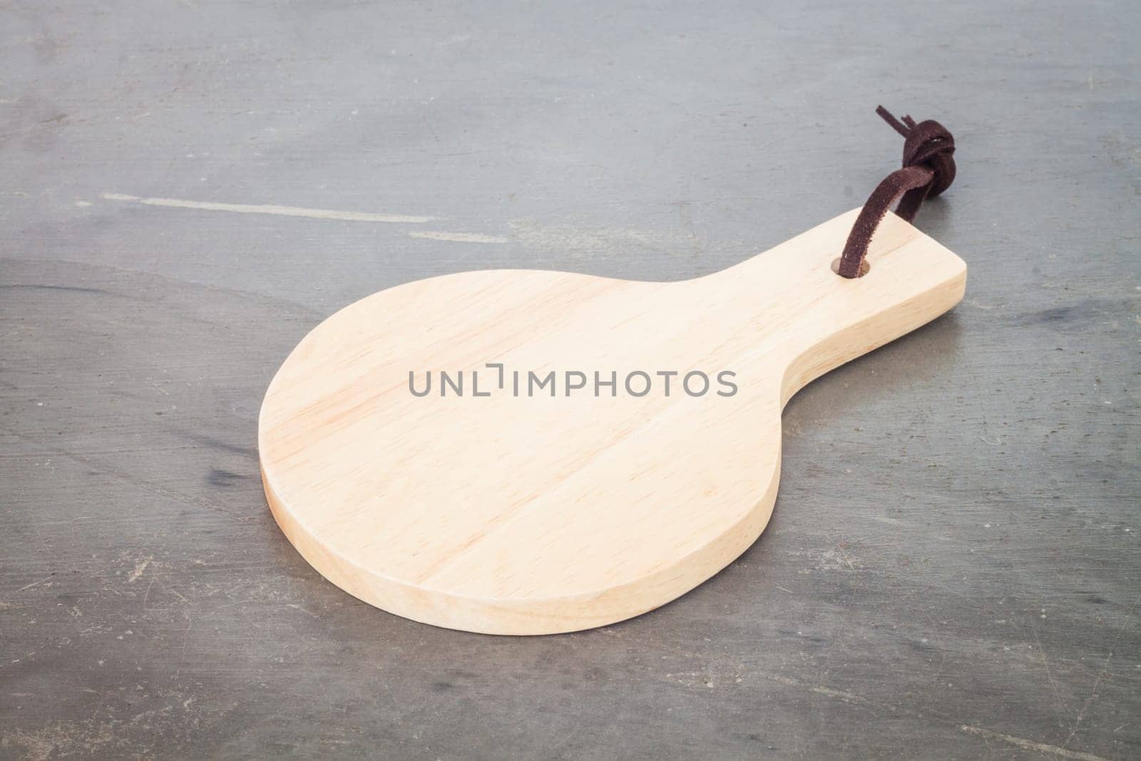 Wooden plate on grey background, stock photo