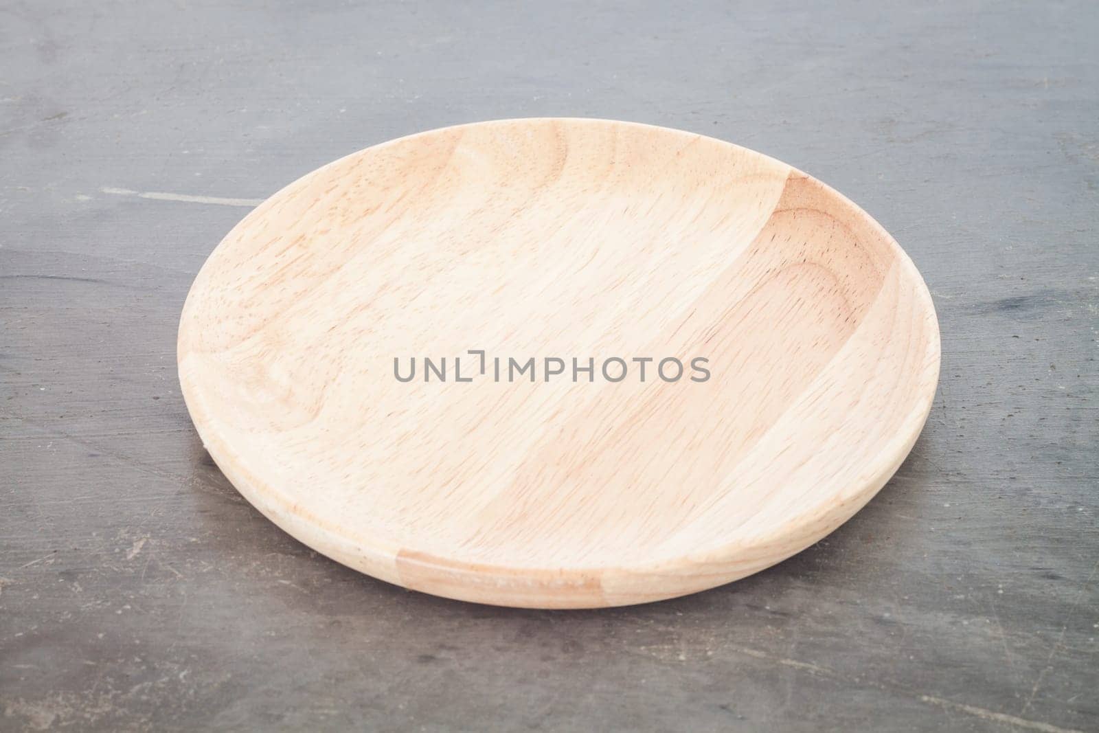 Wooden plate on grey background, stock photo