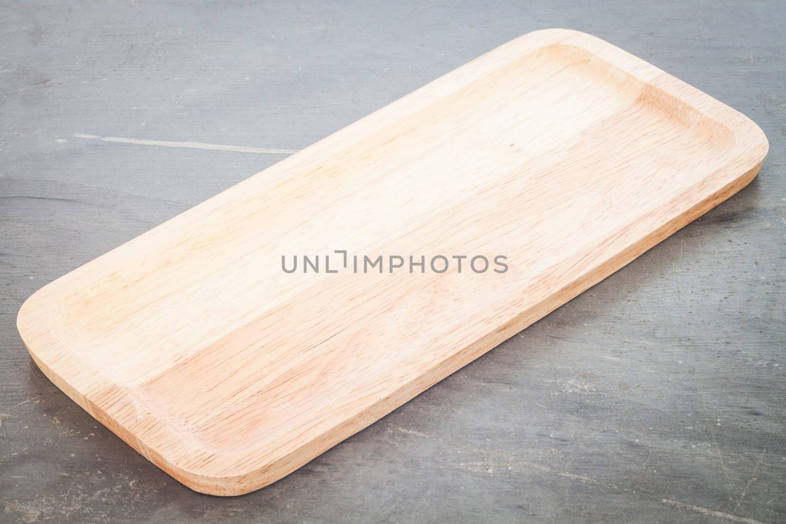 Wooden plate on grey background, stock photo