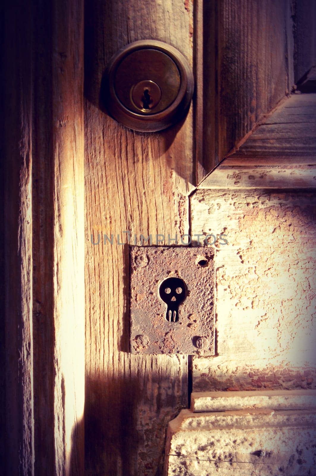Old wood door with spooky skull keyhole vintage background ideal for Halloween poster.