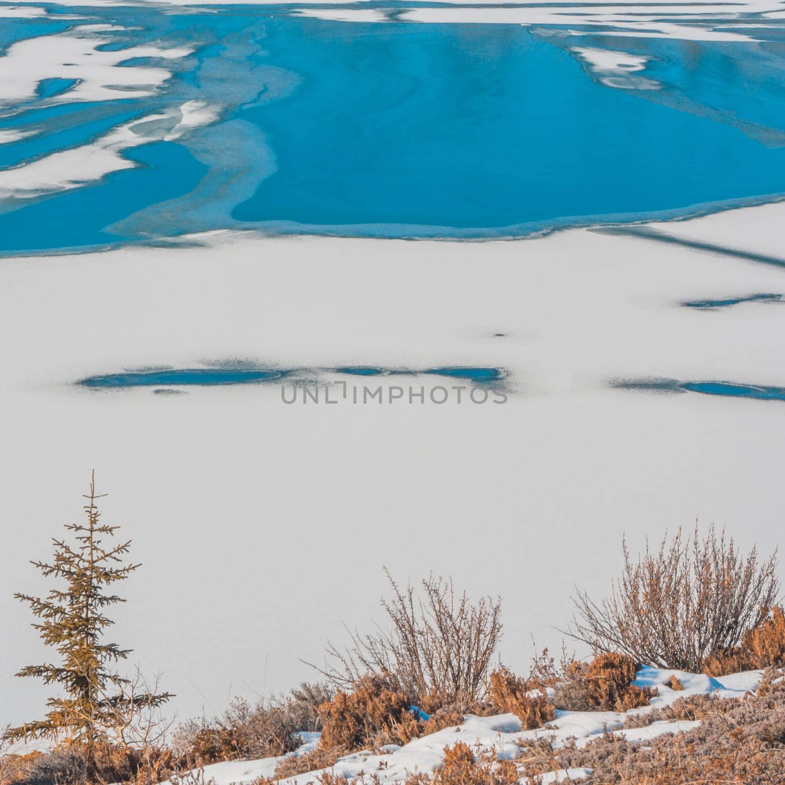 Landscape of snowy textures and blue ice.