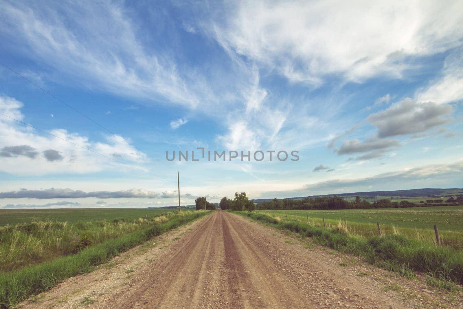 Landscape of a summer country road on a cloudy day.