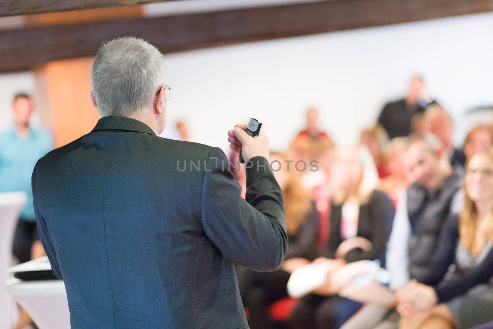 Speaker at Business Conference with Public Presentations. Audience at the conference hall. Entrepreneurship club. Rear view. Horisontal composition. Background blur.