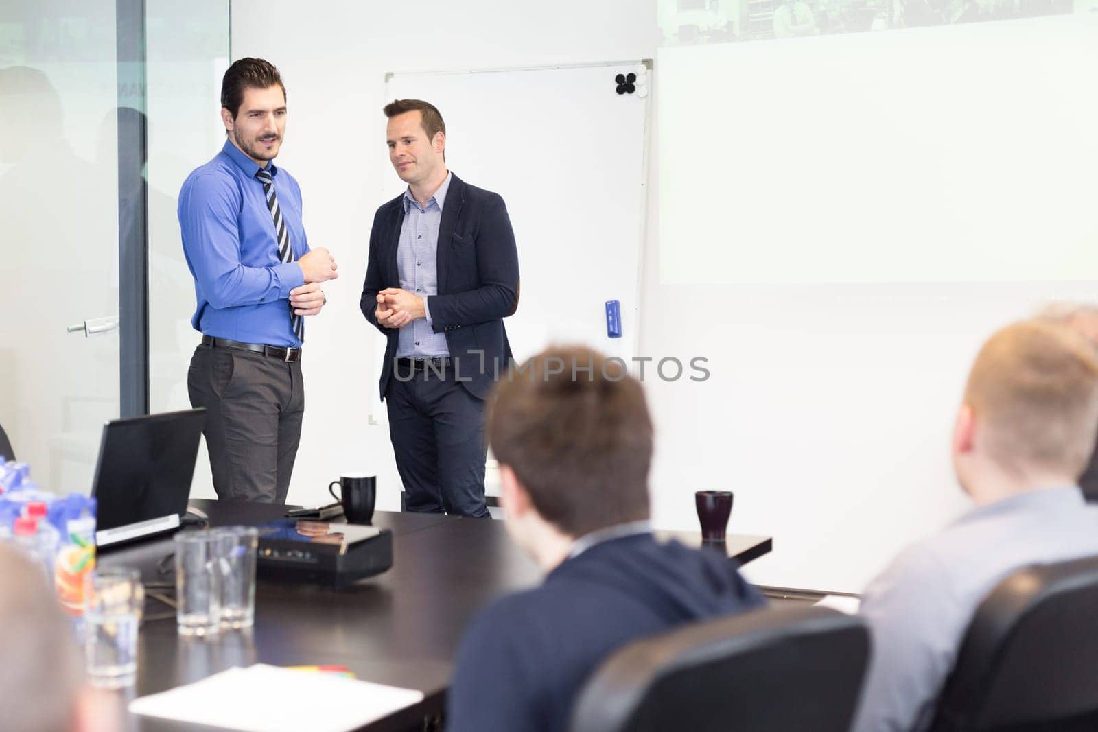 Workplace in modern office with business people brainstorming. Businessman working on laptop during the meeting.