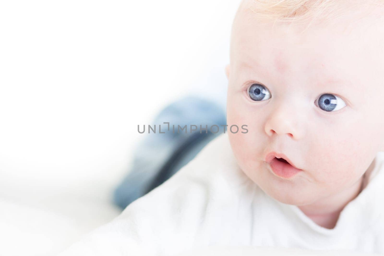 Cute blonde little baby boy with blue eyes.