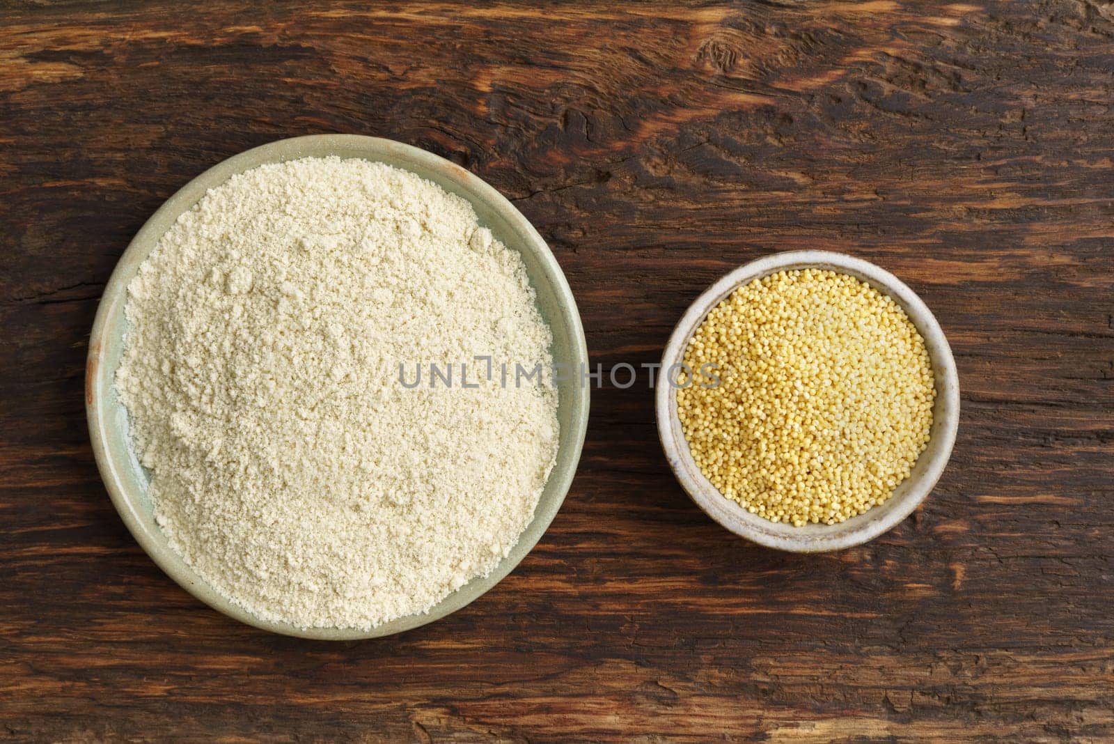Millet and millet flour in small potted bowls