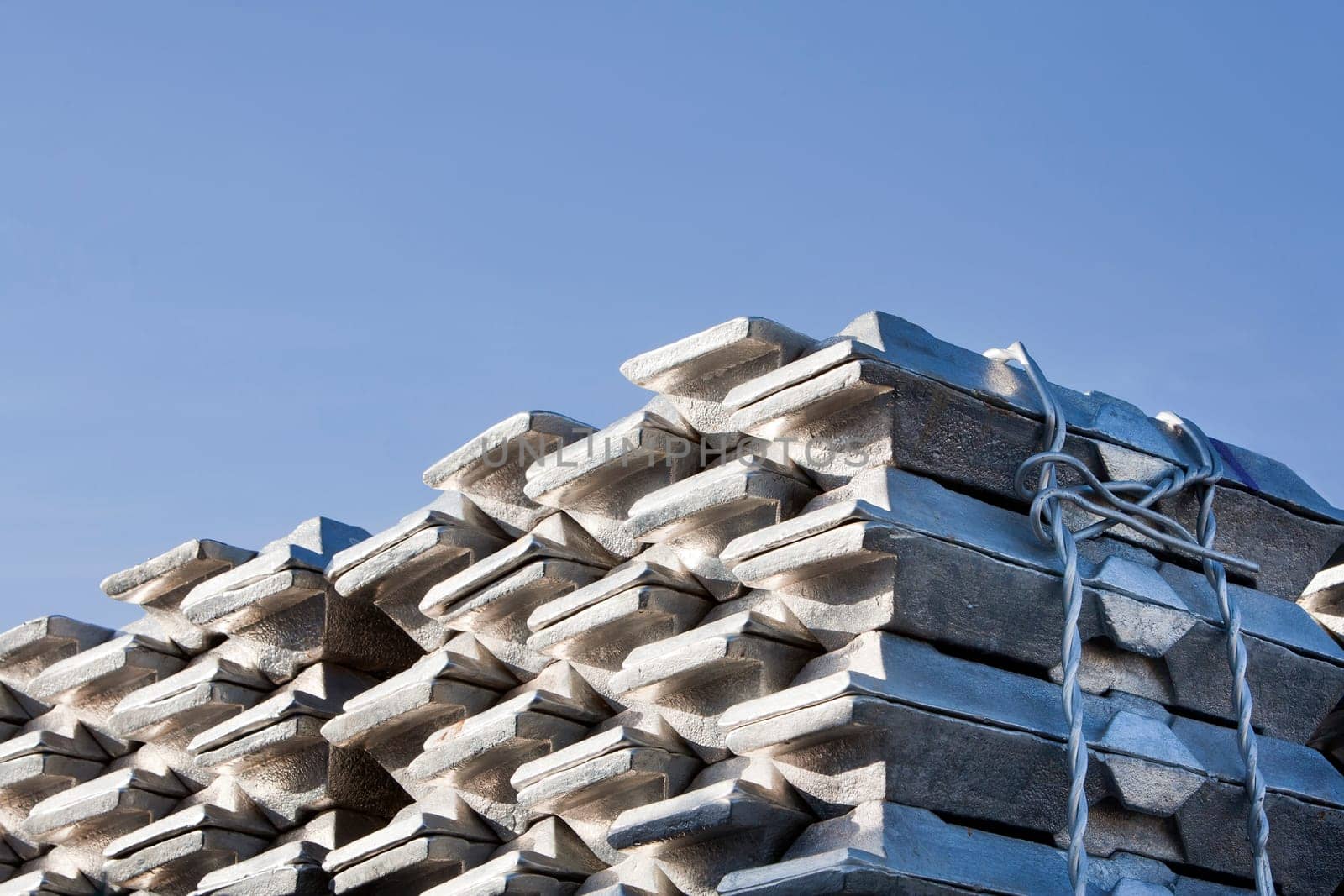 Shiny aluminum ingots and a blue sky