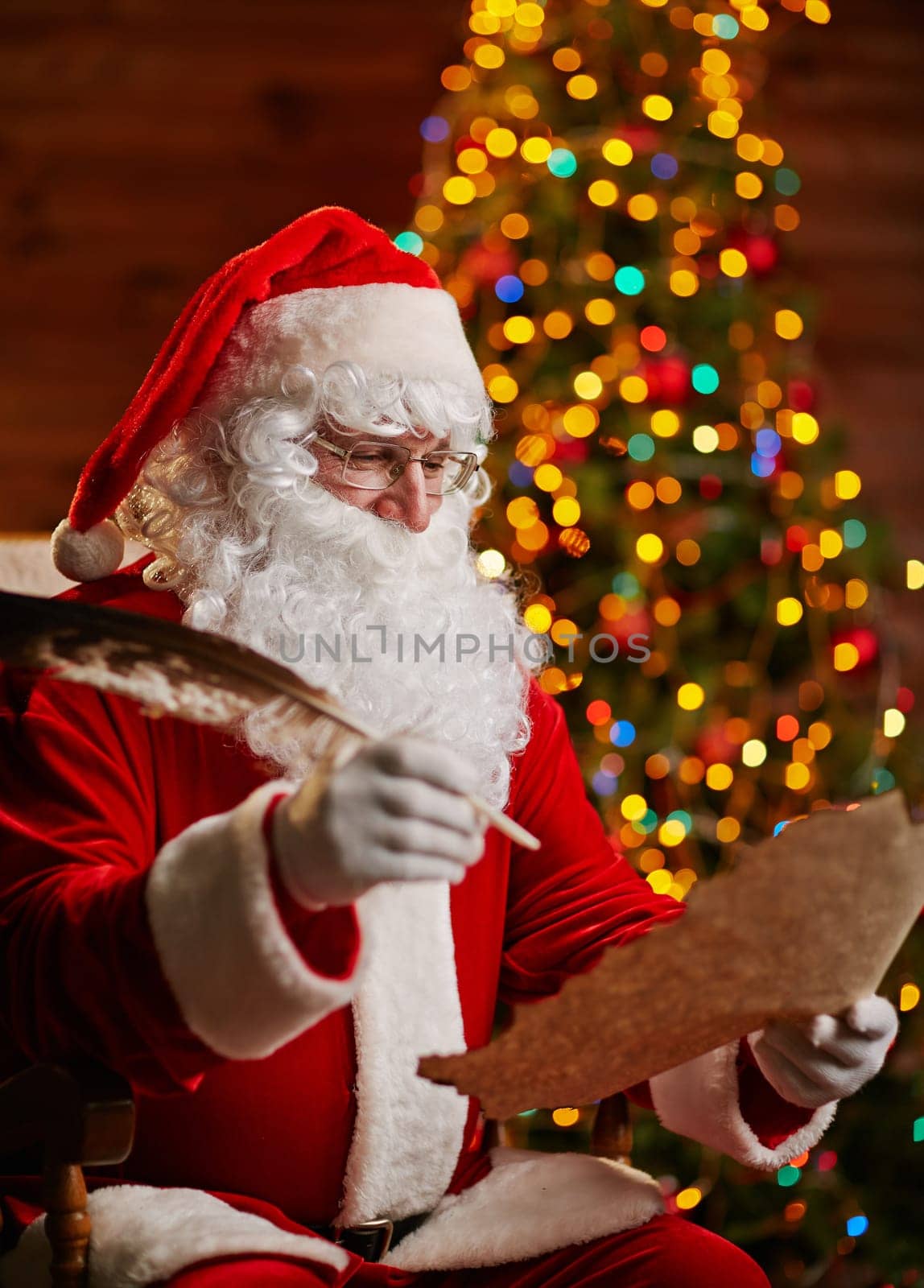 Santa Claus with feather answering Christmas letter