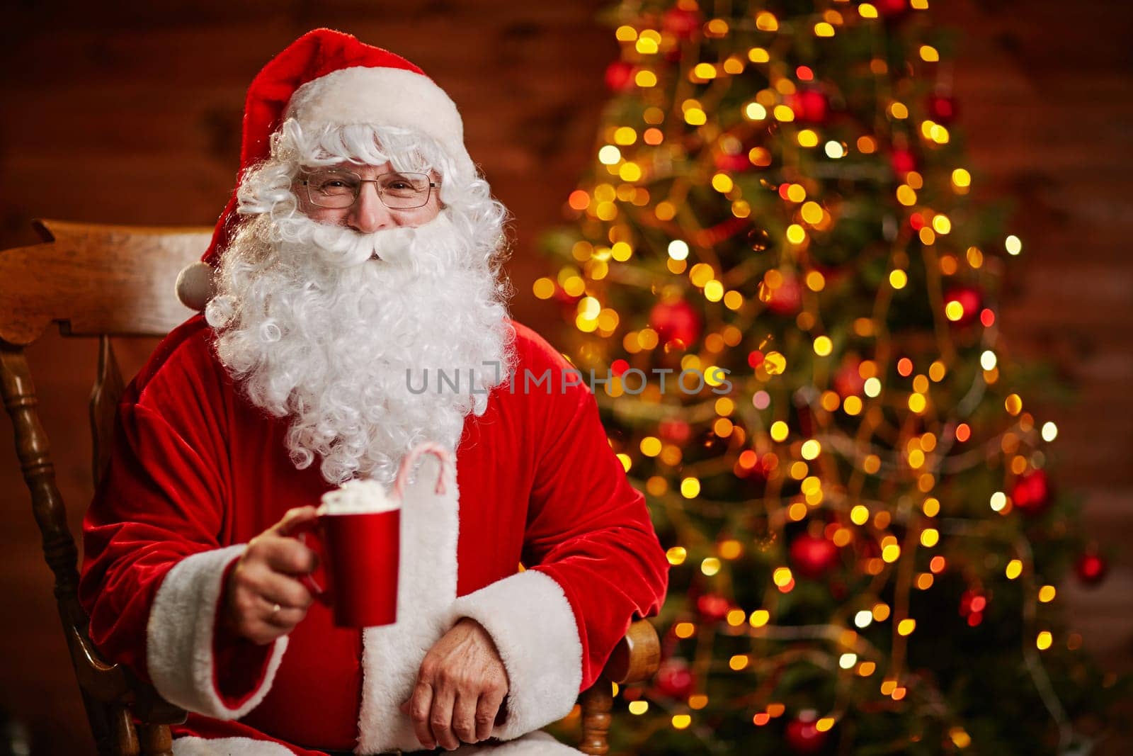 Joyful Santa with cup of latte offering toast for Christmas