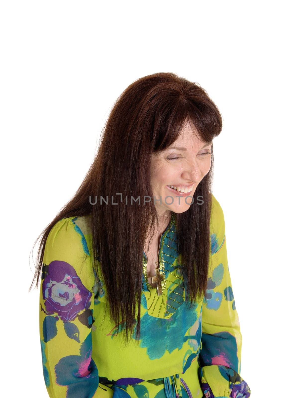 A middle age woman in a nice dress and long brunette hair having fun .and laughing, isolated for white background..