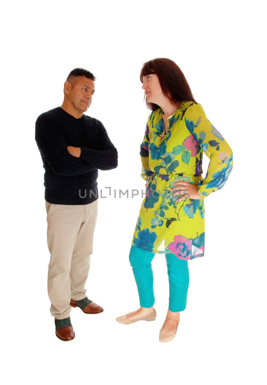 An Caucasian woman looking very frustrated at her Hispanic husband,.standing in front of him, isolated for white background..