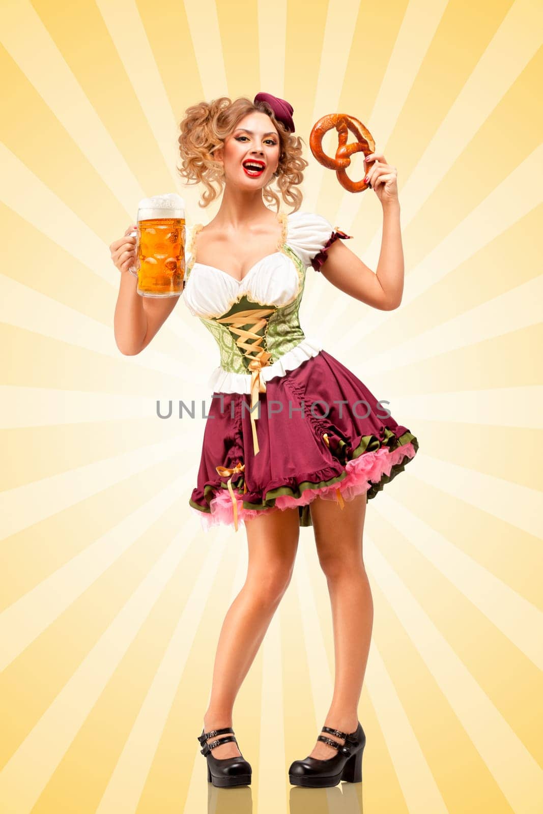Beautiful sexy Oktoberfest waitress wearing a traditional Bavarian dress dirndl holding a pretzel and beer mug, and smiling happily on colorful abstract cartoon style background.