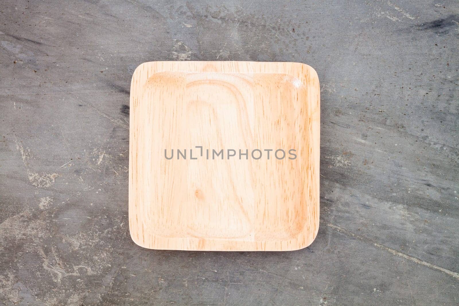 Wooden plate on grey background, stock photo