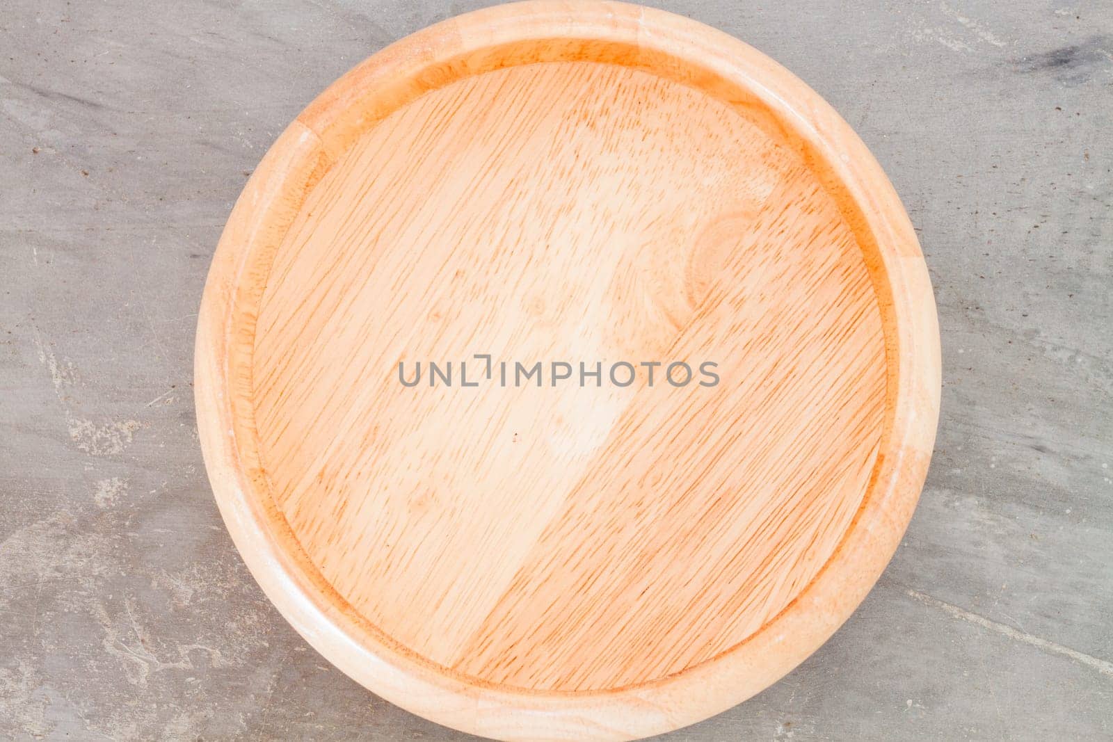 Wooden plate on grey background, stock photo