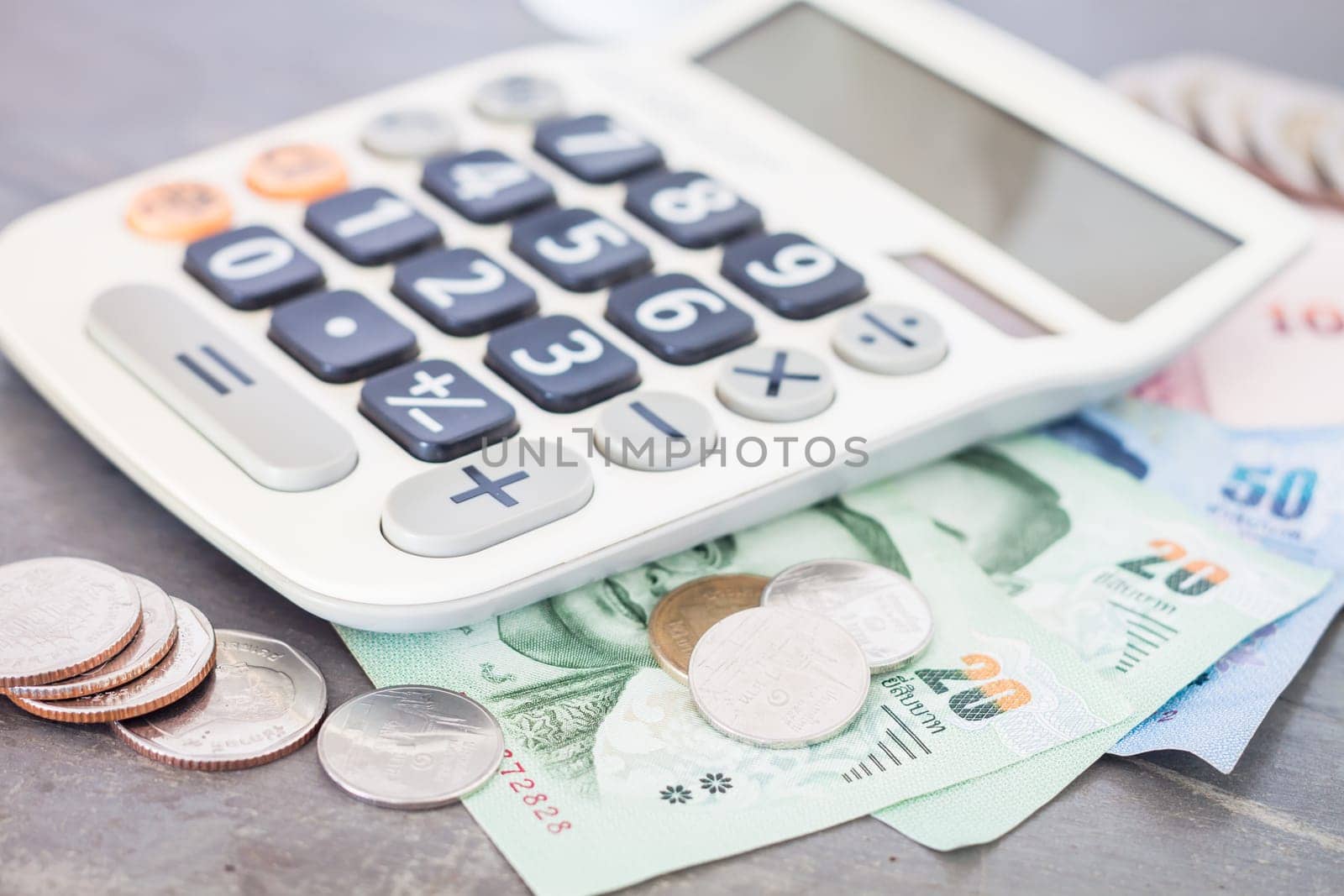 Calculator with money on grey background, stock photo