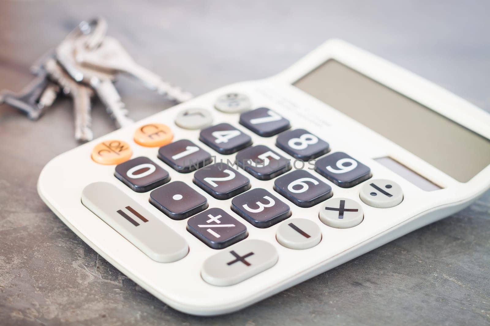 Calculator with keys on grey background, stock photo