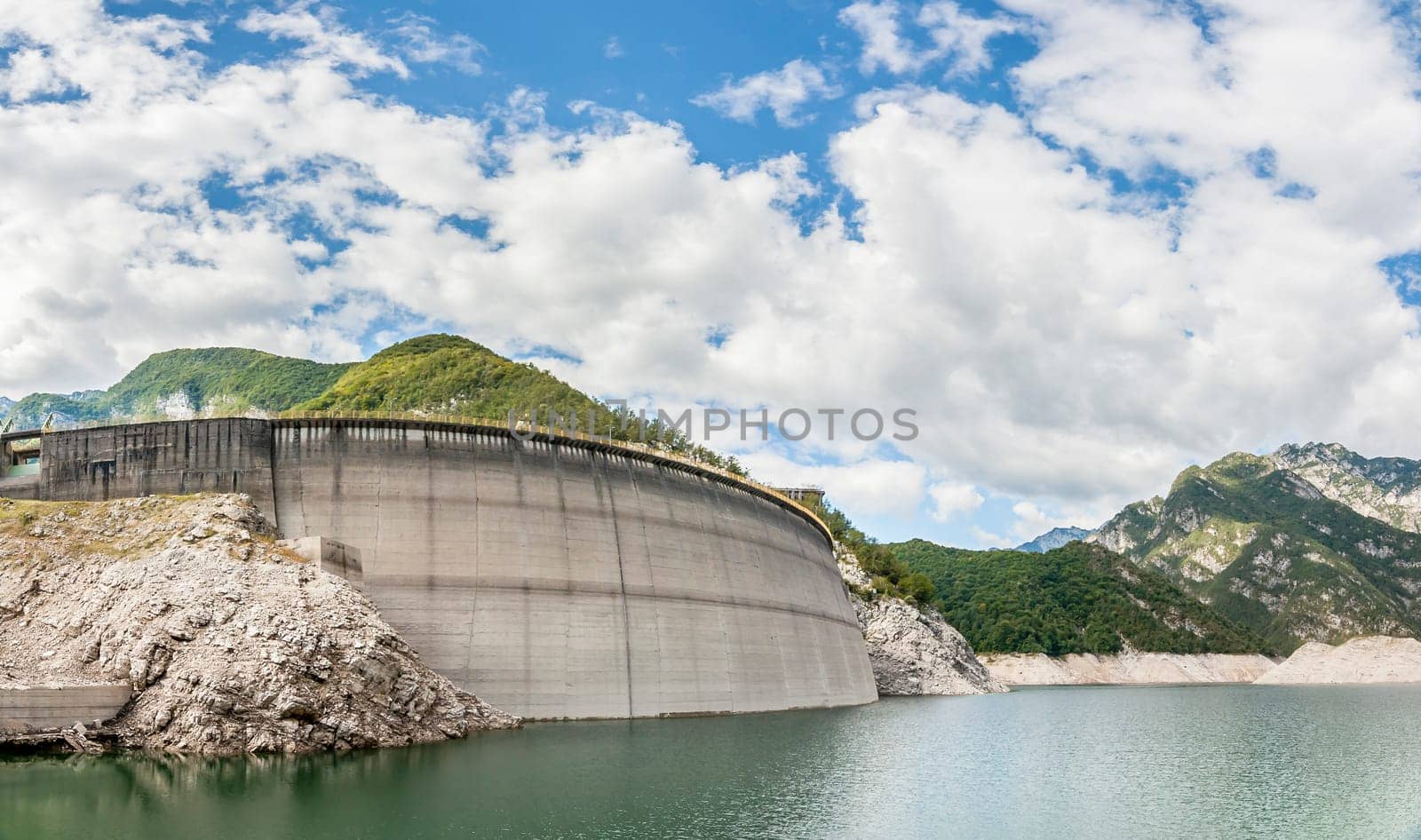 Landscape with dam for the production of electrical energy in the mountains