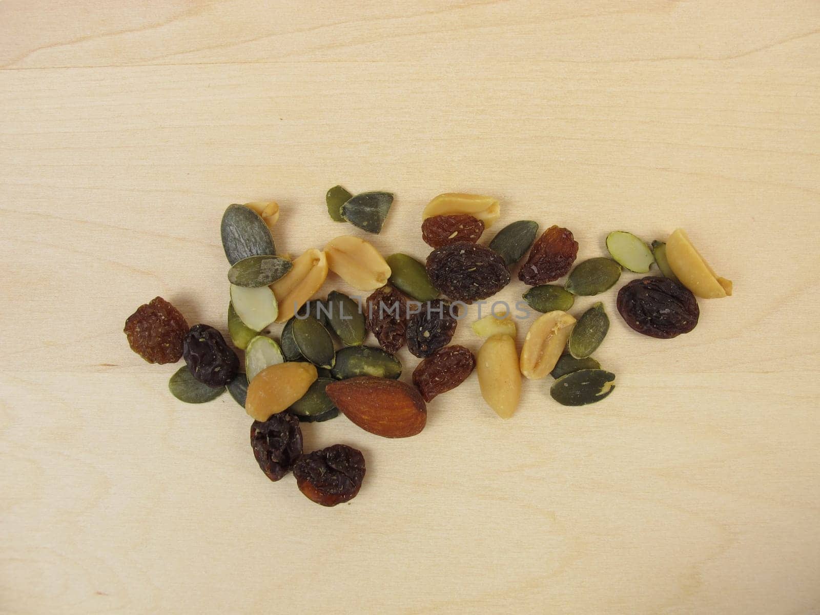 Nuts,seeds and raisins on a wooden background