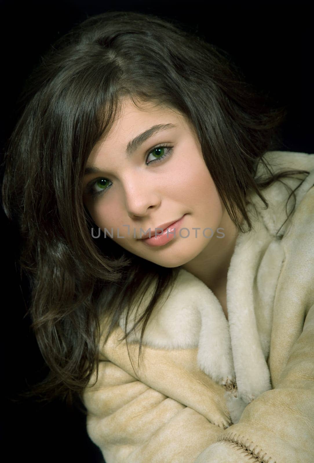 young beautiful brunette portrait against black background