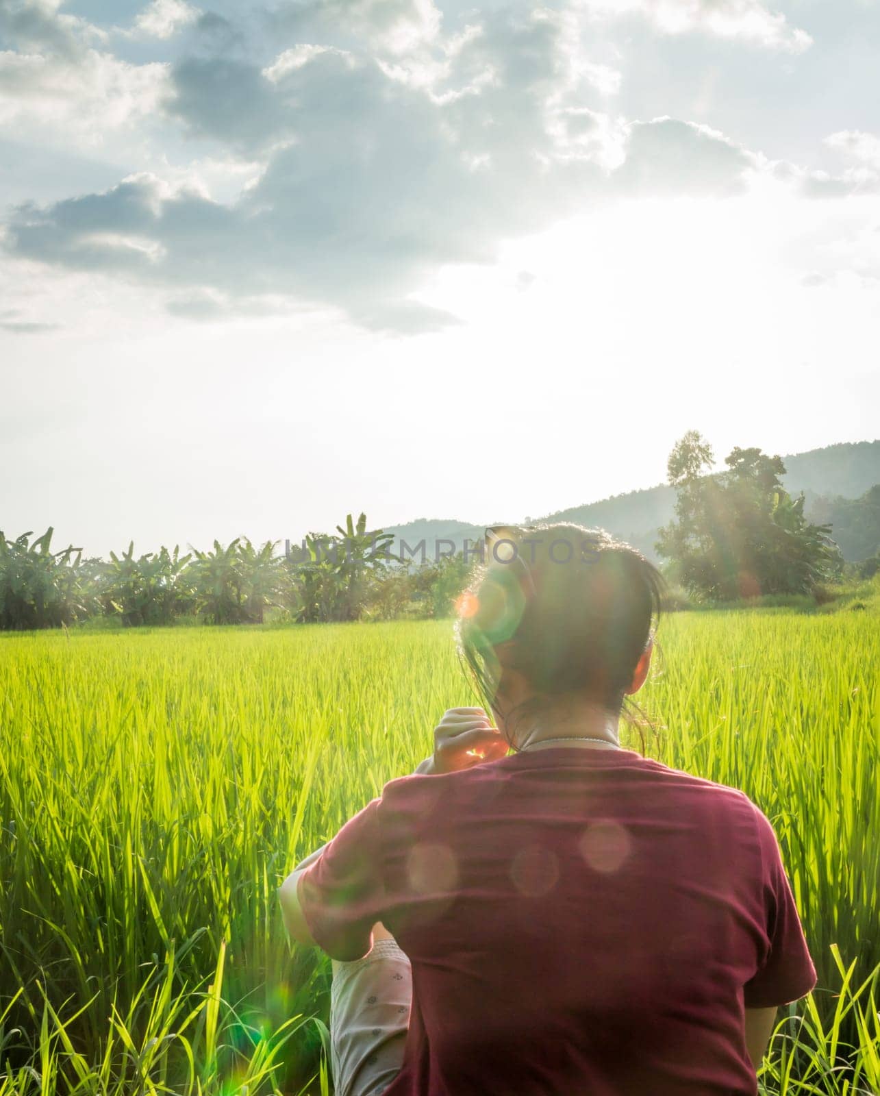 Asian woman enjoy green scenery of  rice field, stock photo