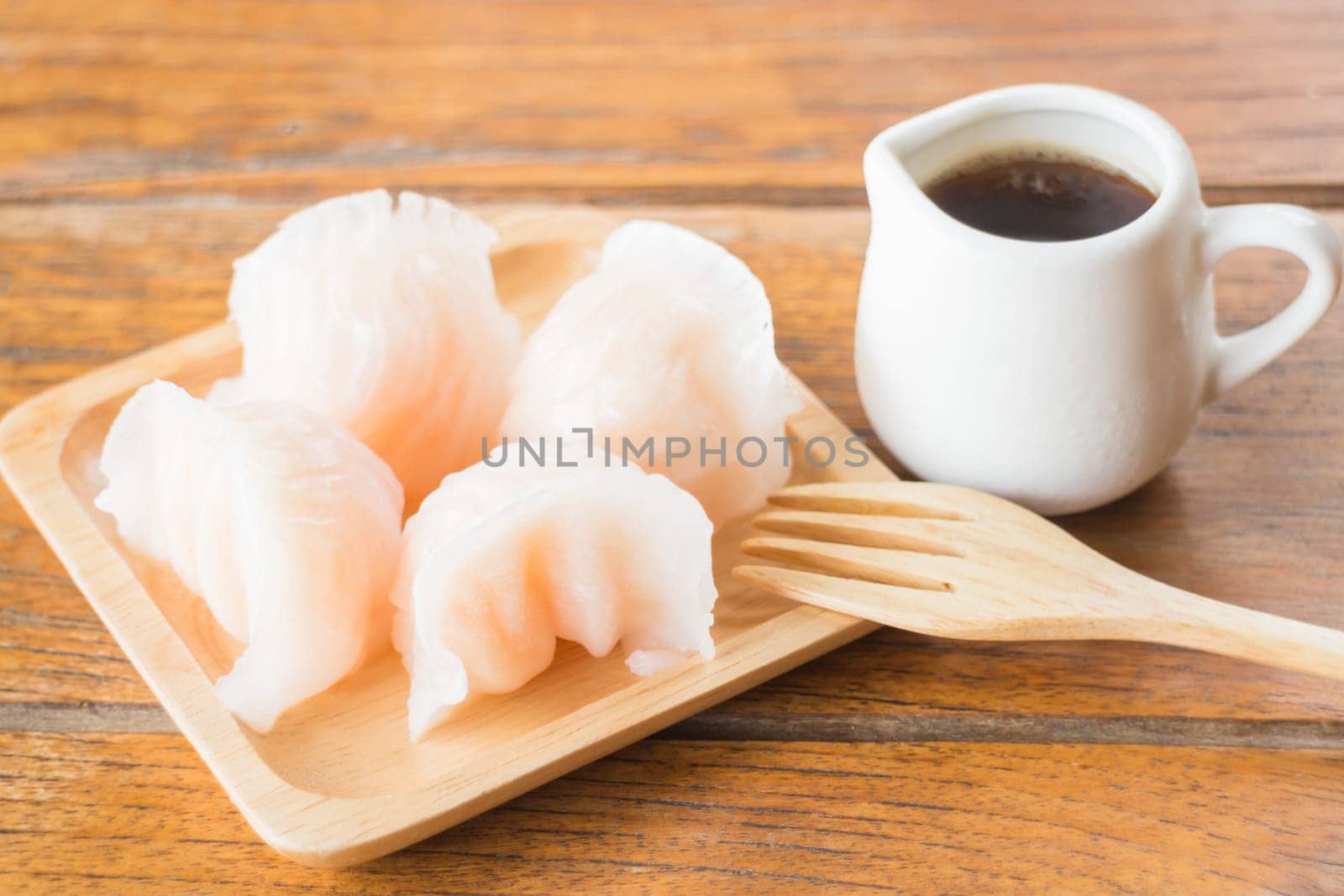 Chinese har gao dim sum dumplings on wooden plate, stock photo