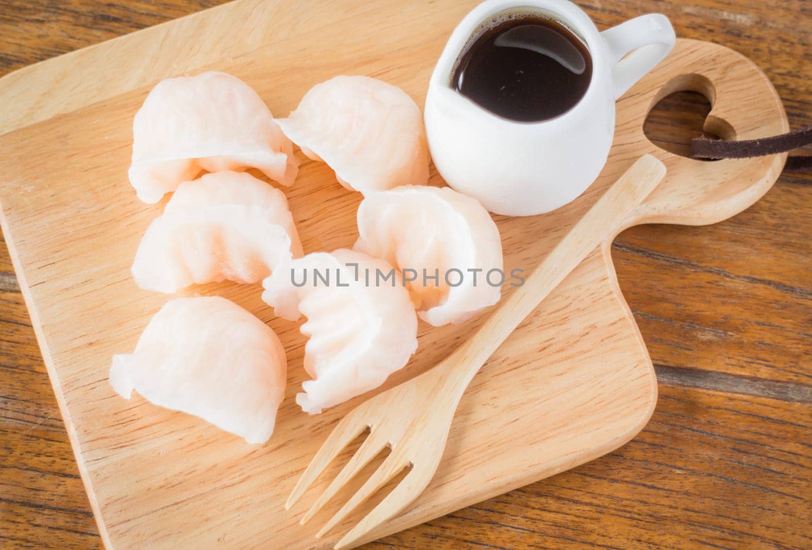 Chinese har gao dim sum dumplings on wooden plate, stock photo