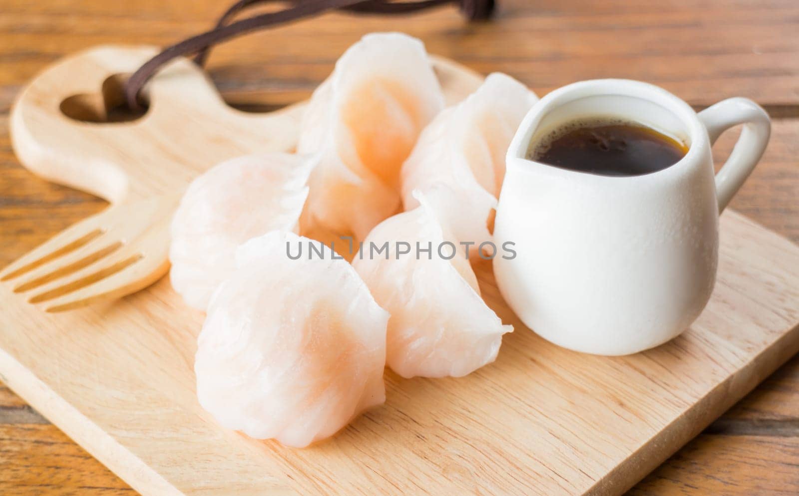 Chinese har gao dim sum dumplings on wooden plate, stock photo
