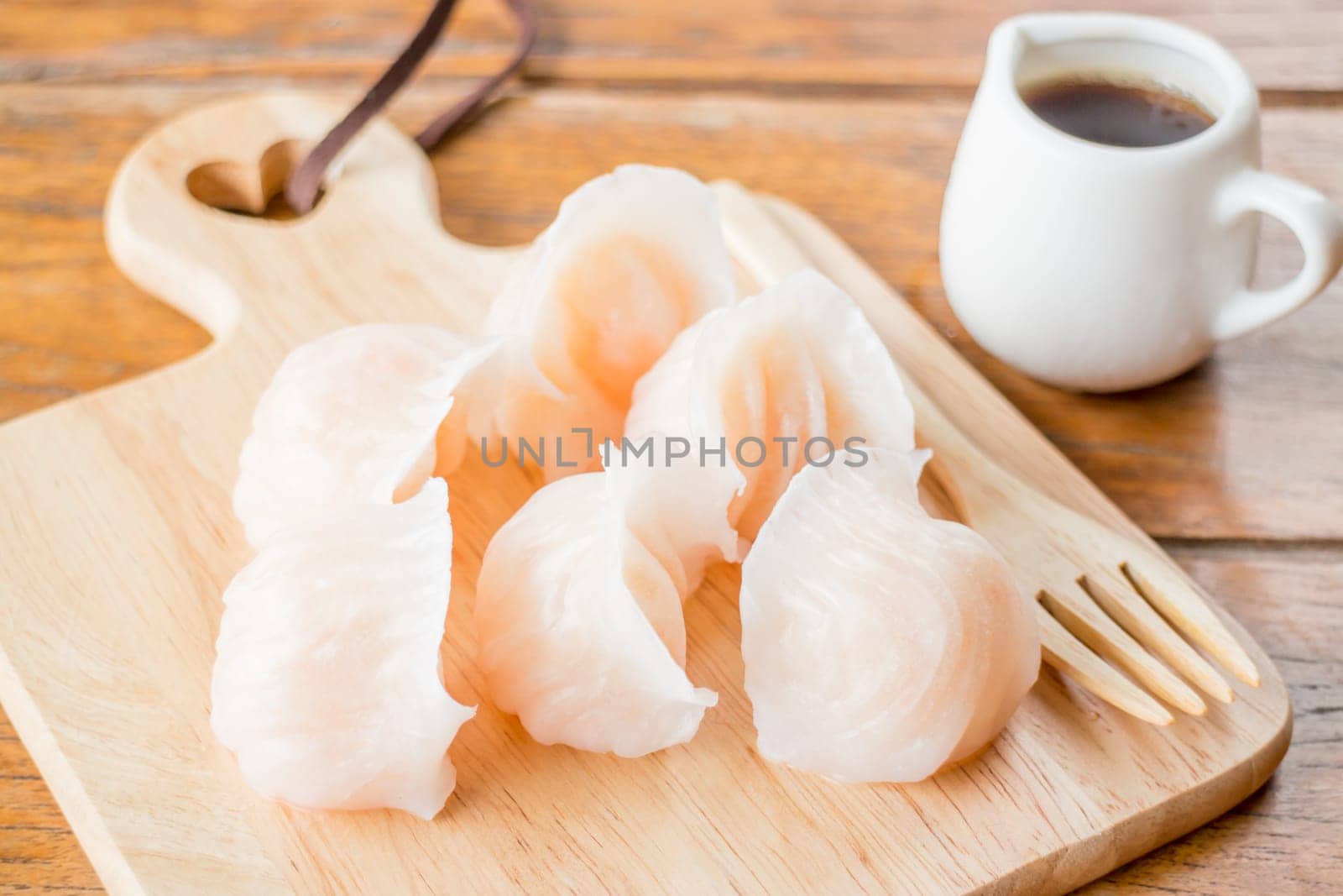 Chinese har gao dim sum dumplings on wooden plate, stock photo