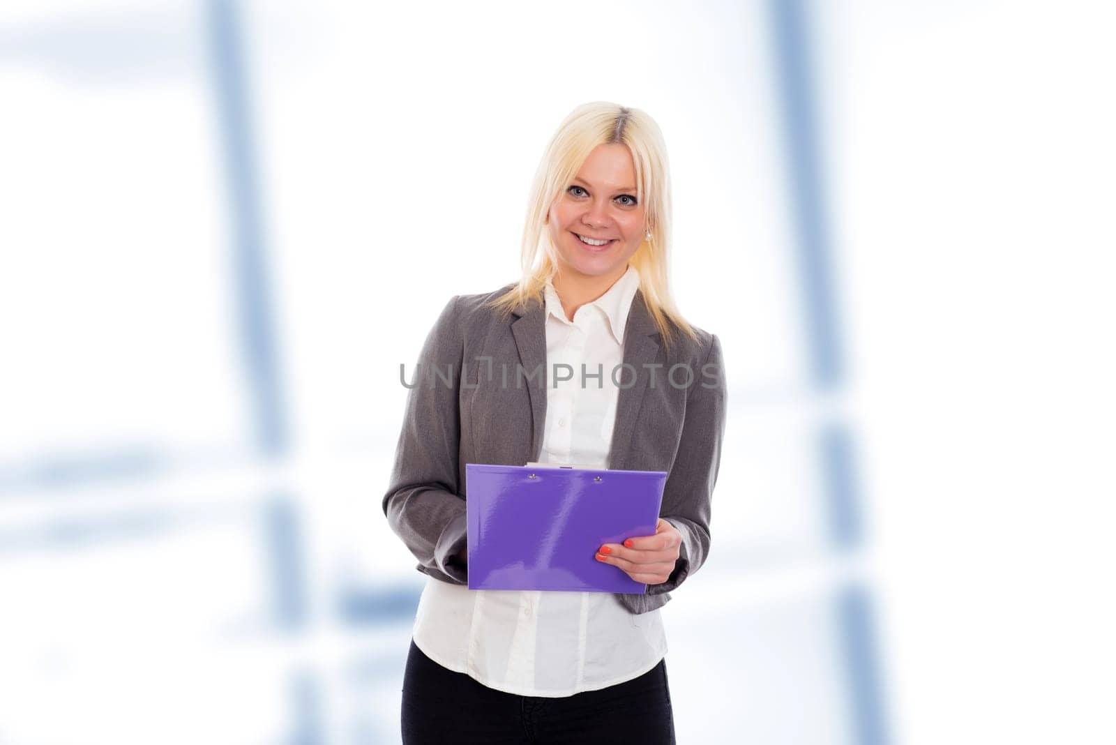 smiling blond young business woman with a clipboard