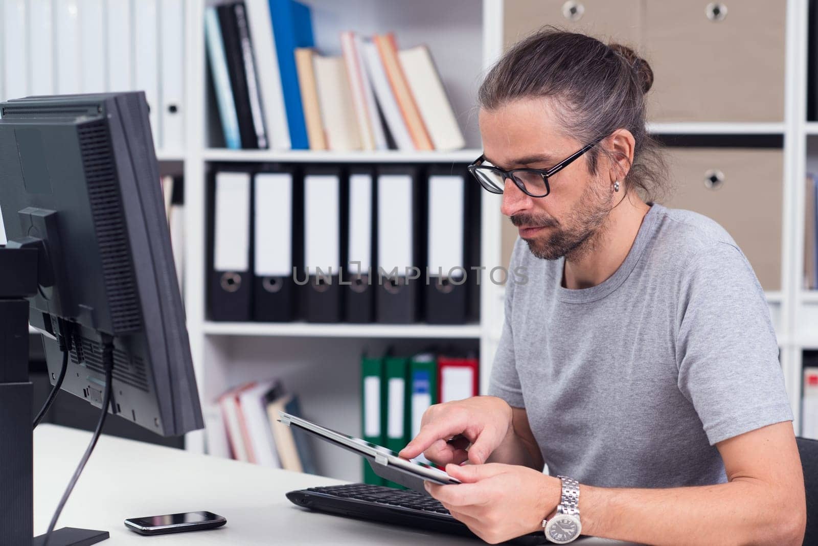 creative man is working in his office with different computer