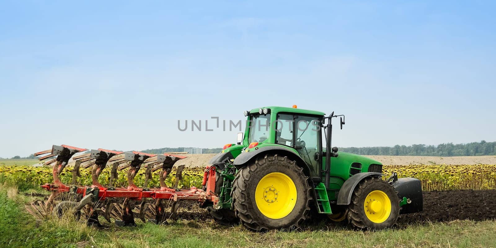 Tractor with plough in the field