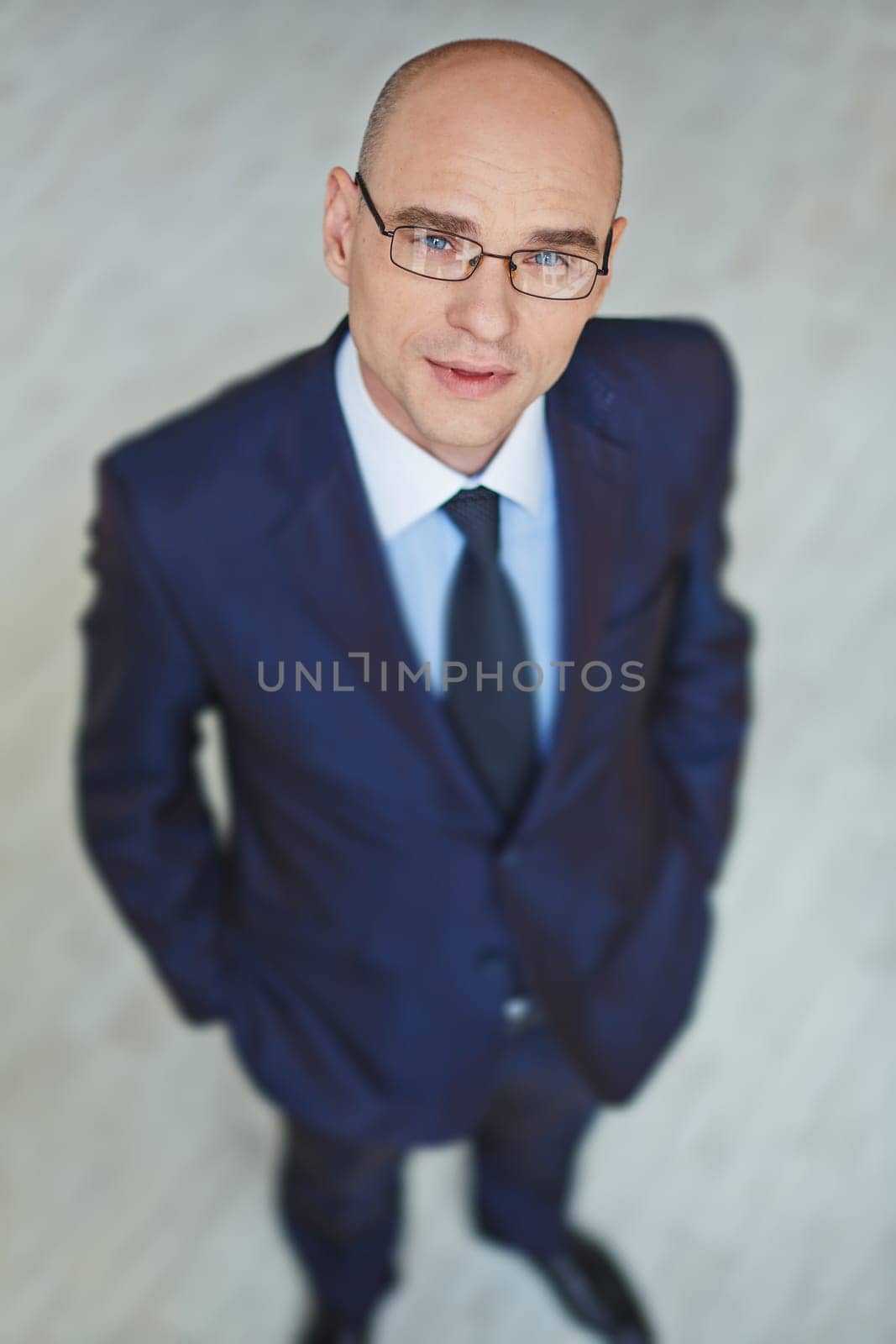 Modern businessman in eyeglasses looking at camera