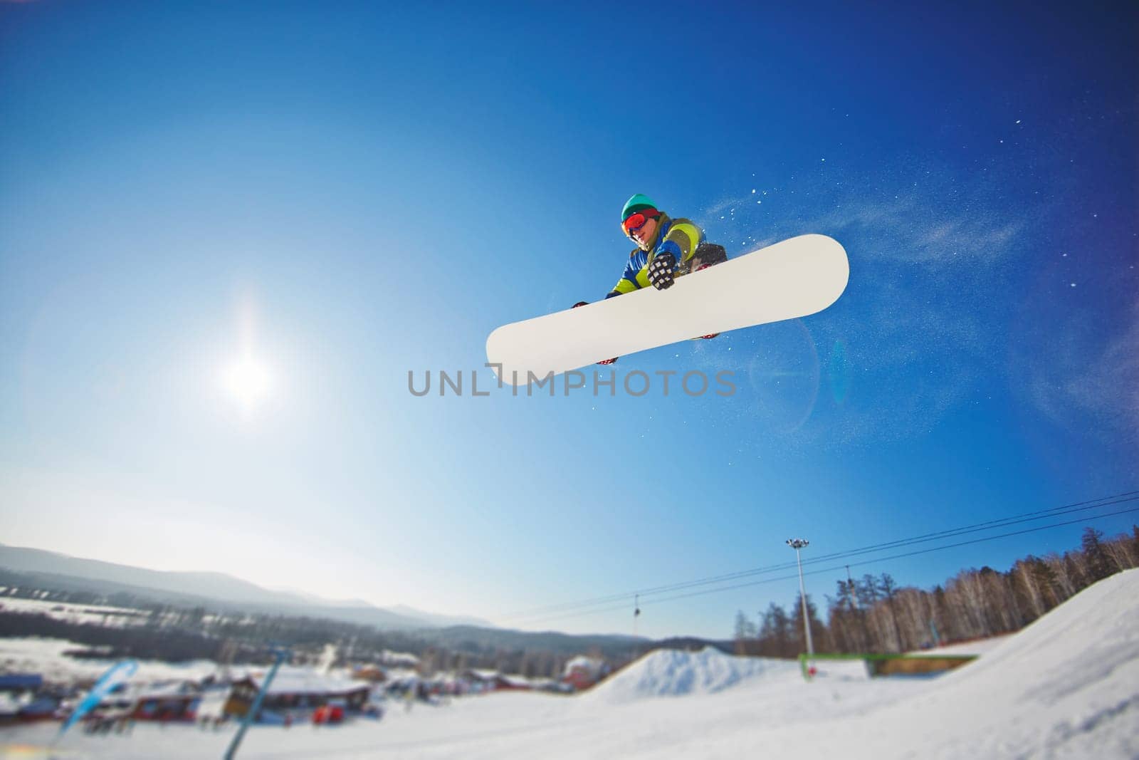 Sportsman on snowboard spending winter vacation on resort