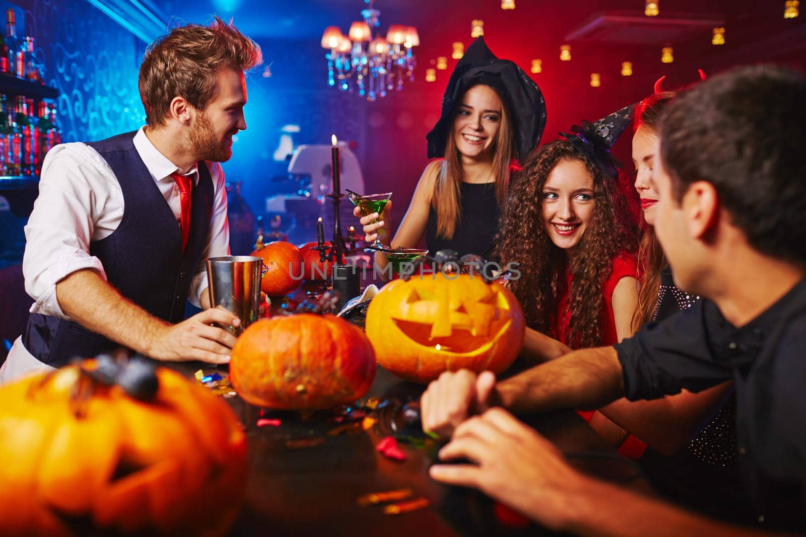 Happy witches celebrating Halloween in bar