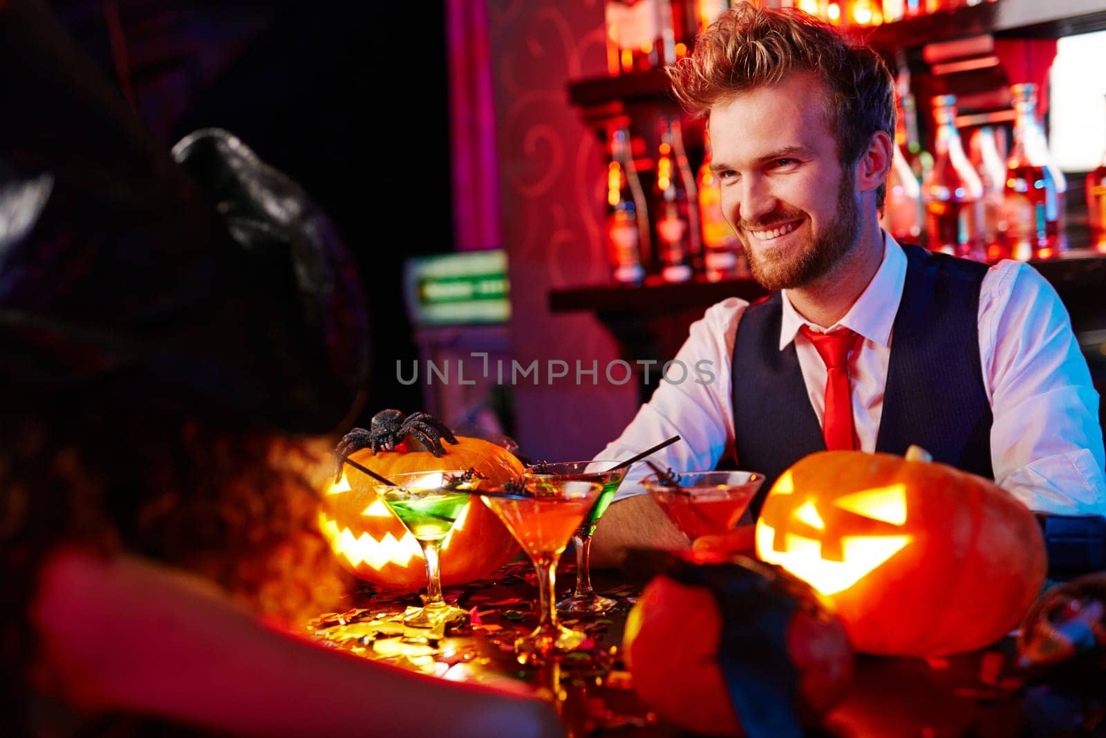 Happy barman welcoming guests on Halloween party