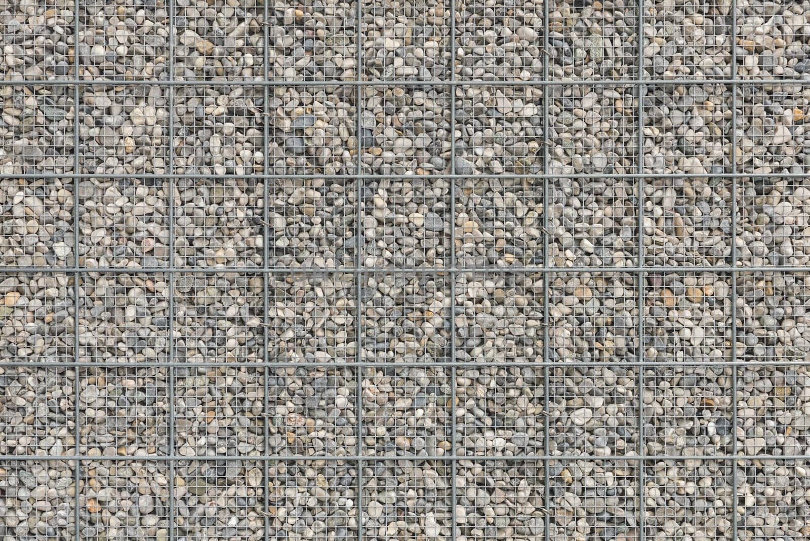 Background with a lot of pebble gravel stones texture filled in wire armature mesh grid