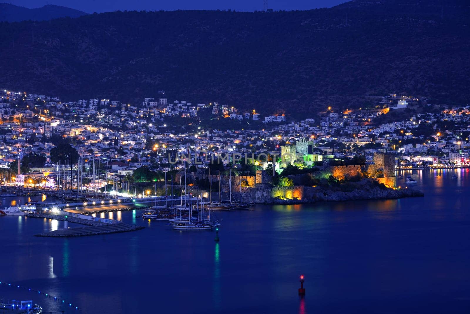 View of Bodrum harbor and Castle of St. Peter by night. Turkish Riviera.